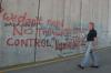 Roger Waters of Pink Floyd spraying graffiti on the apartheid wall